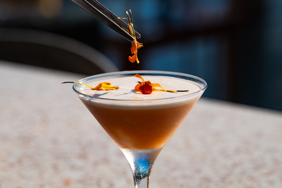 Bartender crafting a signature cocktail at The Narma Bar